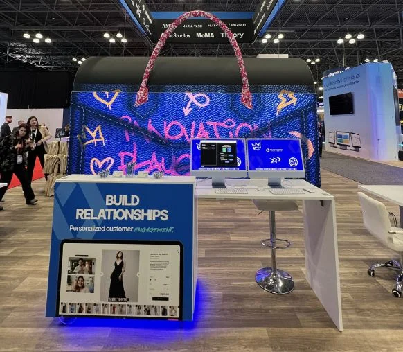 Teamwork Commerce LED retail trade show display with hanging sign and open meeting space