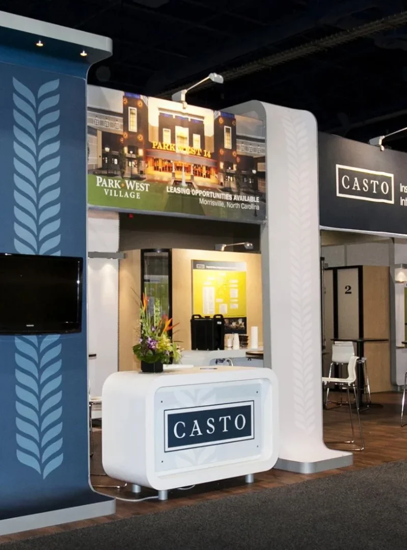 Casto real estate trade show display with property imagery and branded lightbox walls