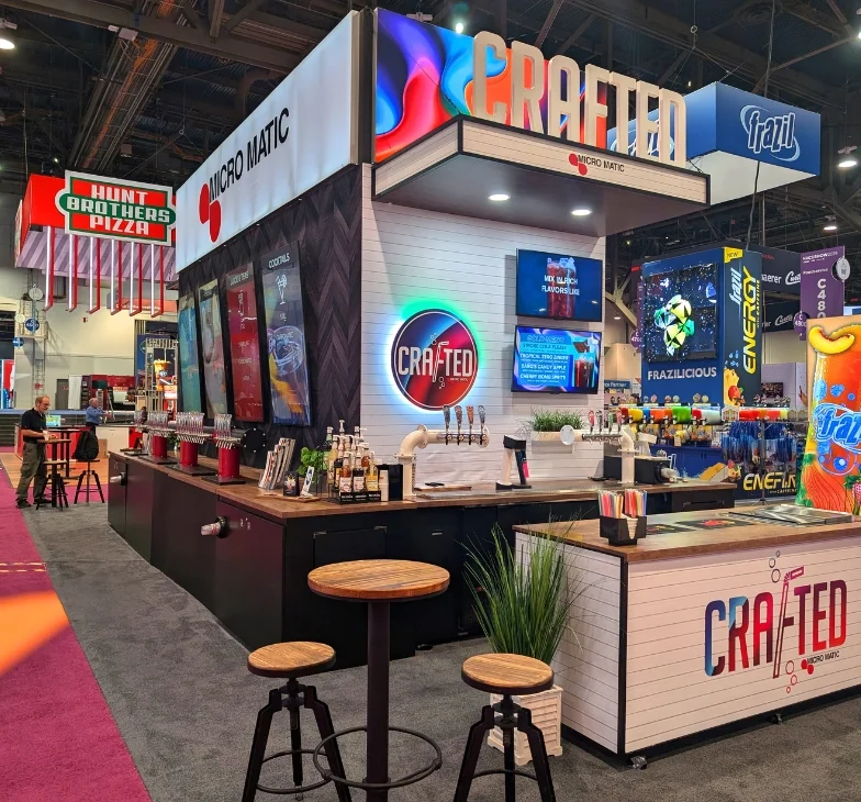 Custom island trade show exhibit with overhead signage