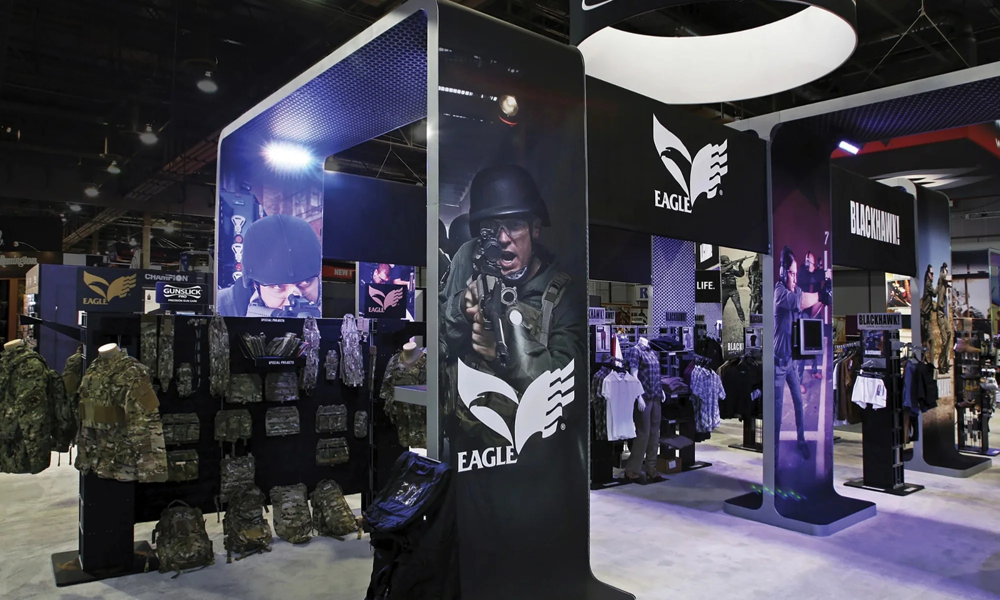 Eagle Industries trade show exhibit with tactical gear, apparel displays, and illuminated graphics by Suncoast Displays