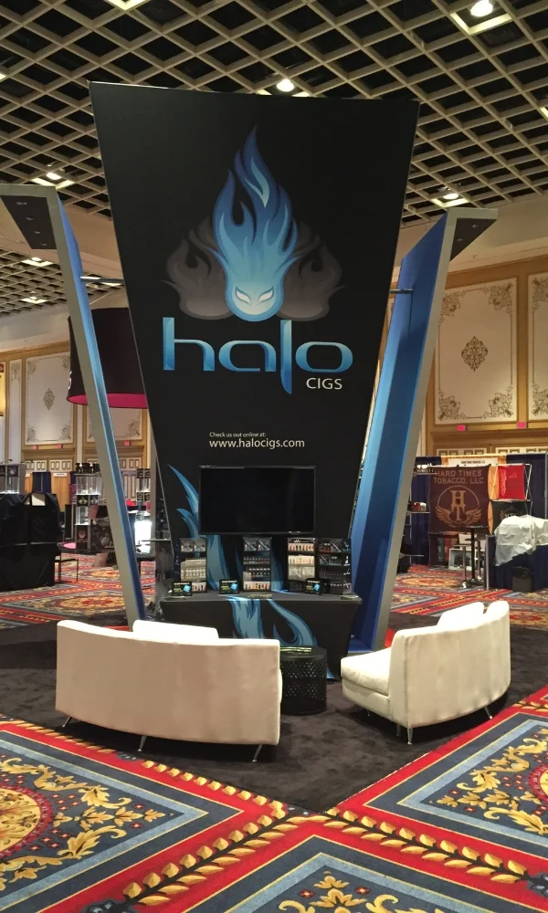 Halo Cigs trade show booth with tall tapered tower, lounge seating, and integrated product shelves by Suncoast Displays