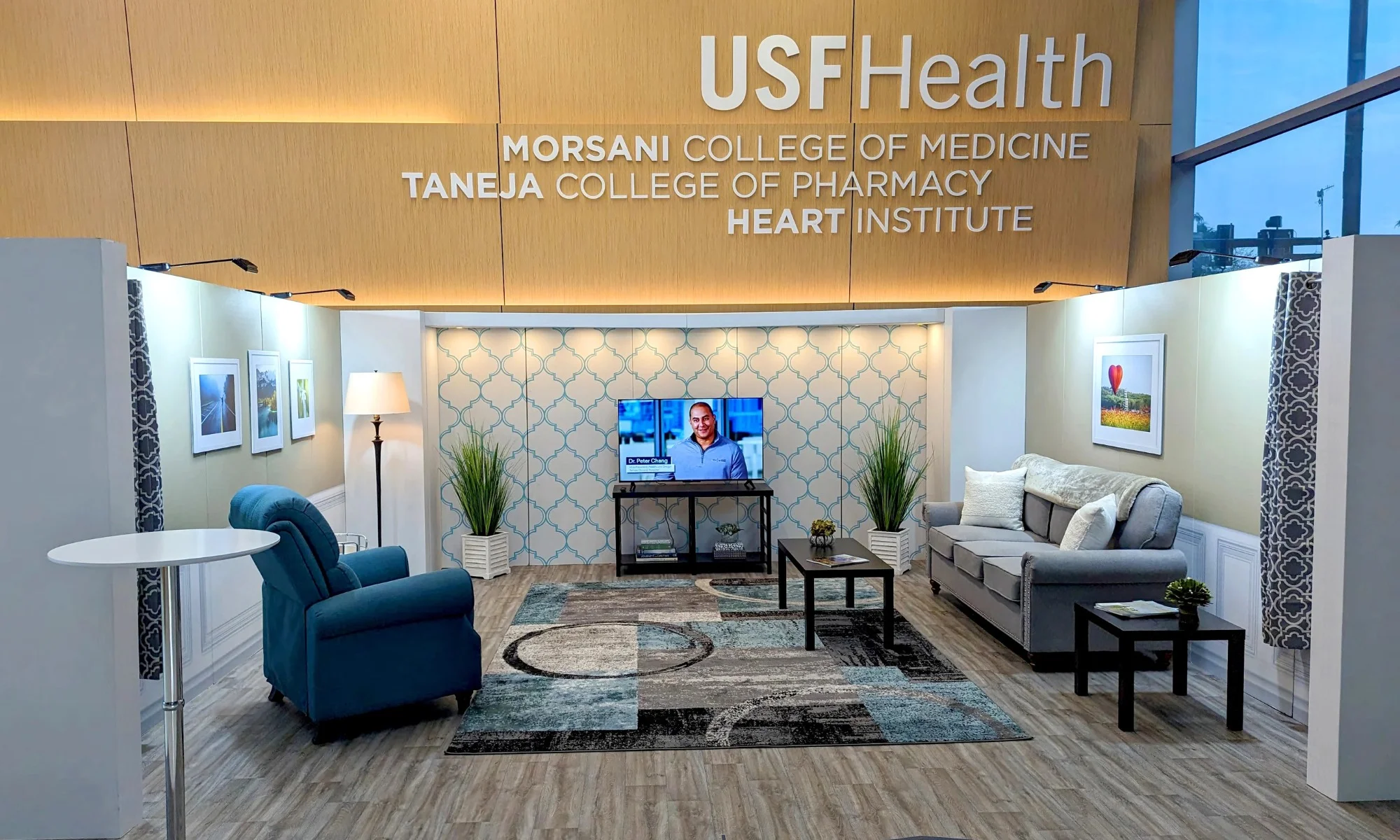 USF Health trade show booth with lounge seating, branded wall graphics, and integrated lighting by Suncoast Displays